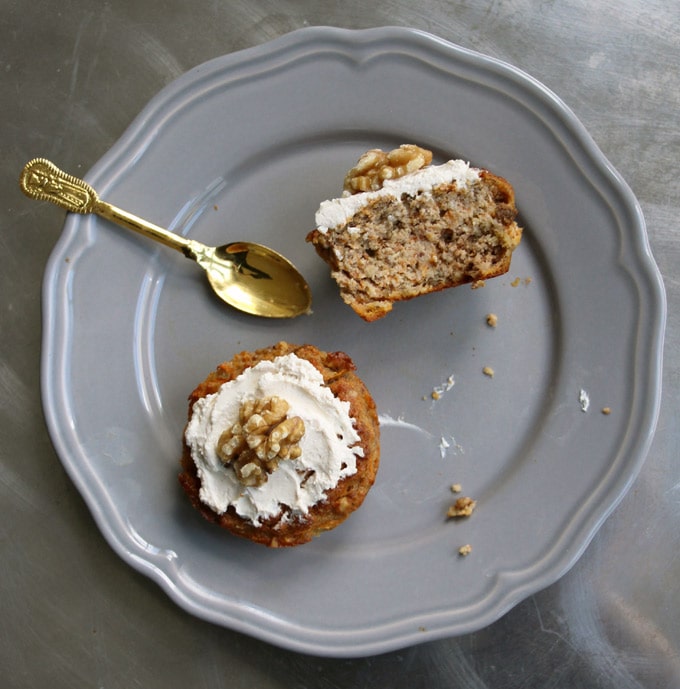 a healthy carrot cake muffin on a plate with a spoon