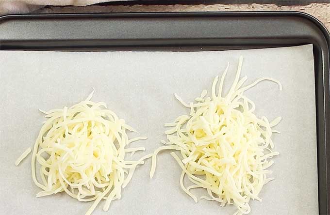 mozzarella heaps on a baking pan lined with parchment paper