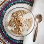 coffee chia pudding topped with crushed nuts and coconut milk