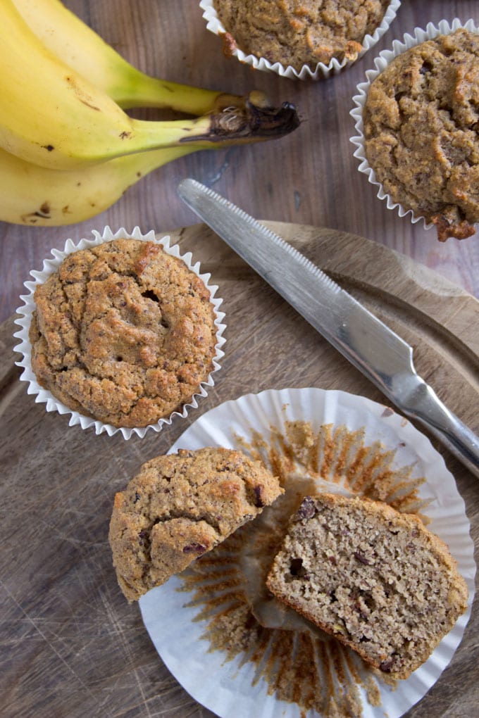 a low carb chocolate banana muffin cut in half and a knife