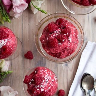 An insanely fruity and refreshing sugar free frozen yoghurt: Crown your meal with a Raspberry Chia Coconut Froyoraspberry frozen yogurt in glass serving bowls on a table with pink roses
