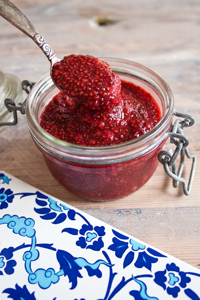 sugar free raspberry jam in a jar with a spoon