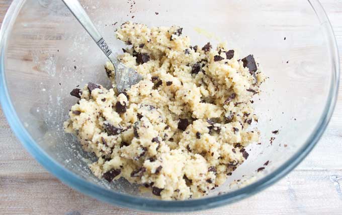 A bowl with chocolate chip cookie dough and a fork
