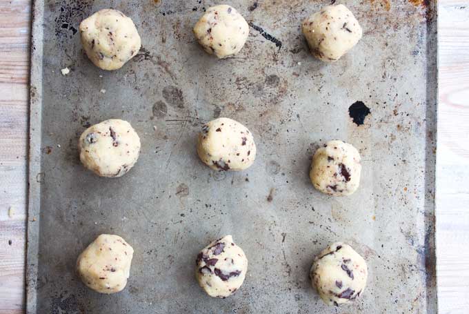 balls of chocolate chip dough placed on a baking tray
