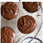 chocolate cupcakes with chocolate frosting on a cake stand