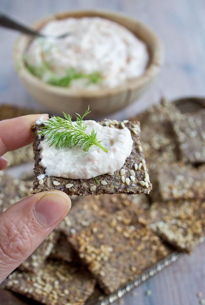 hand holding a flaxseed cracker