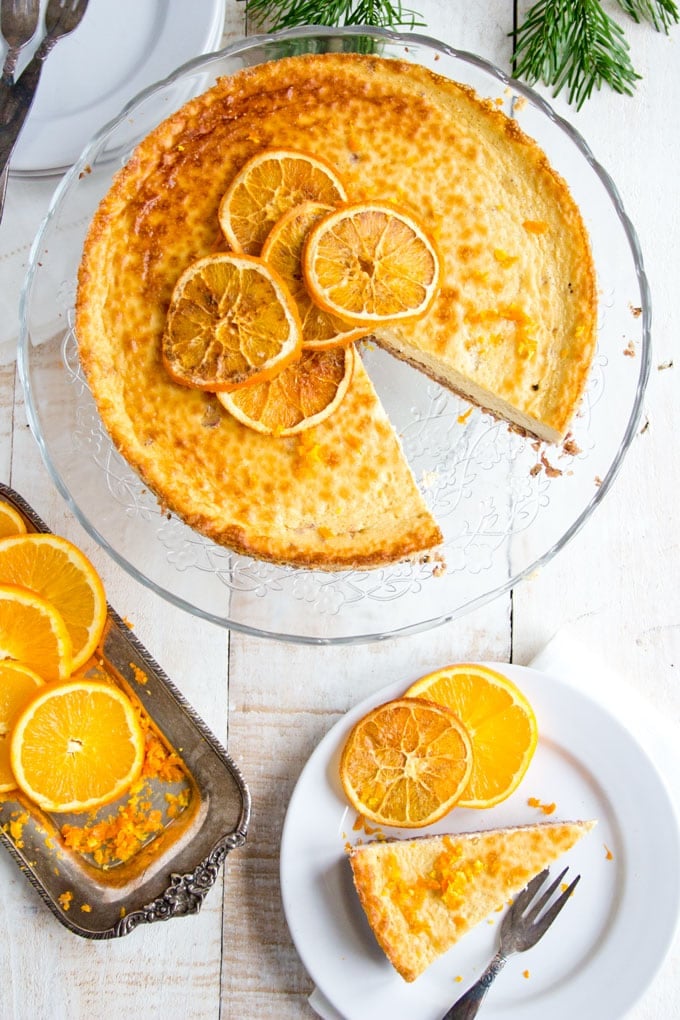 An orange cheesecake on a cake stand