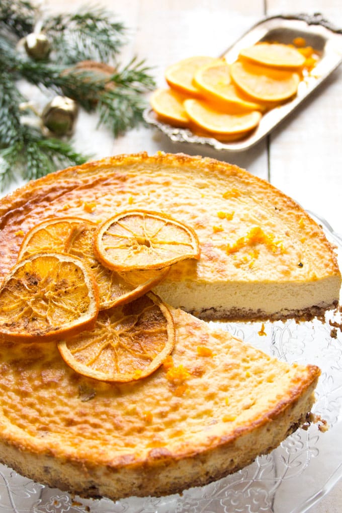 A orange cheesecake with a slice cut out