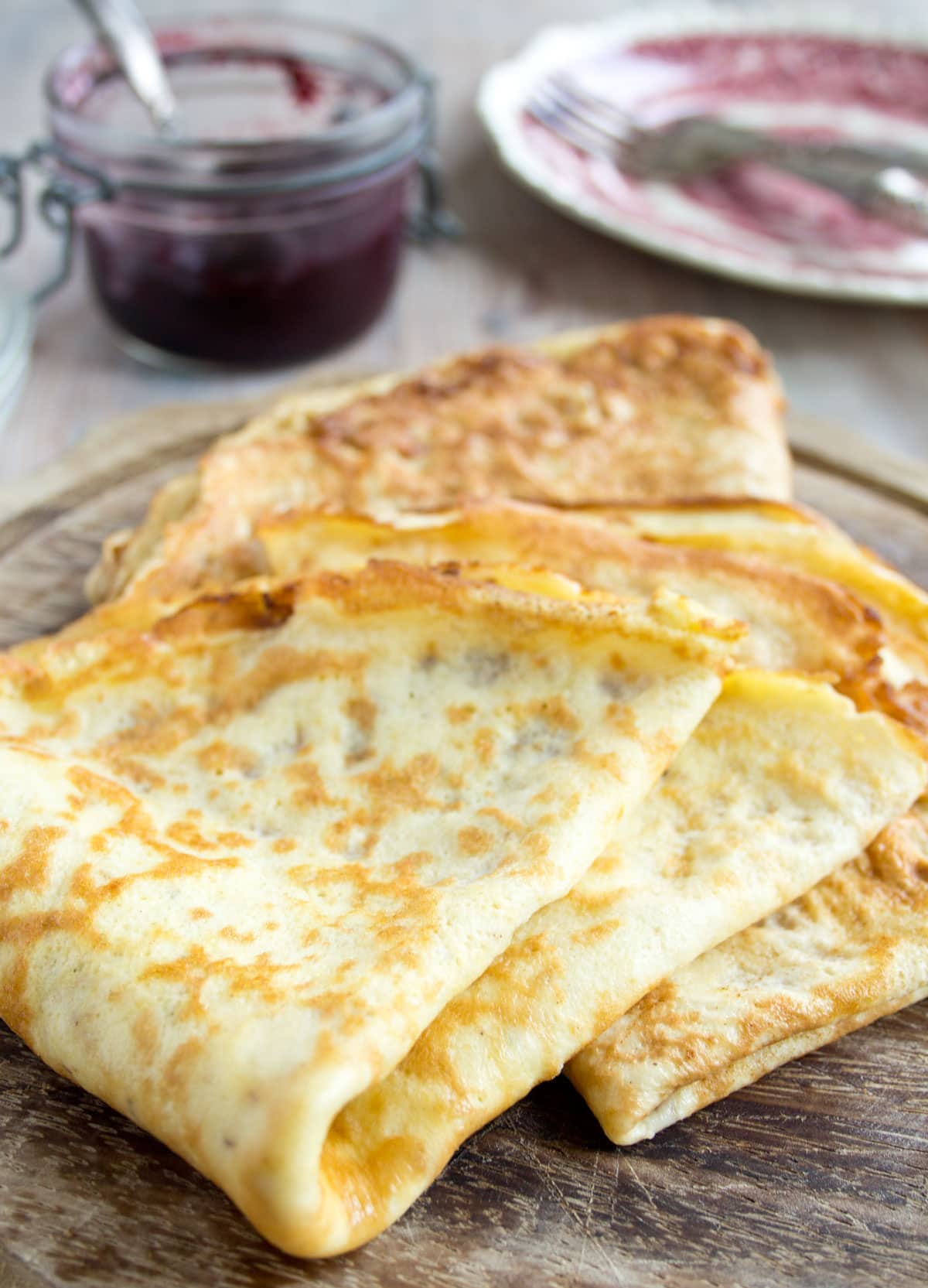 Folded crepes on a wooden tray.