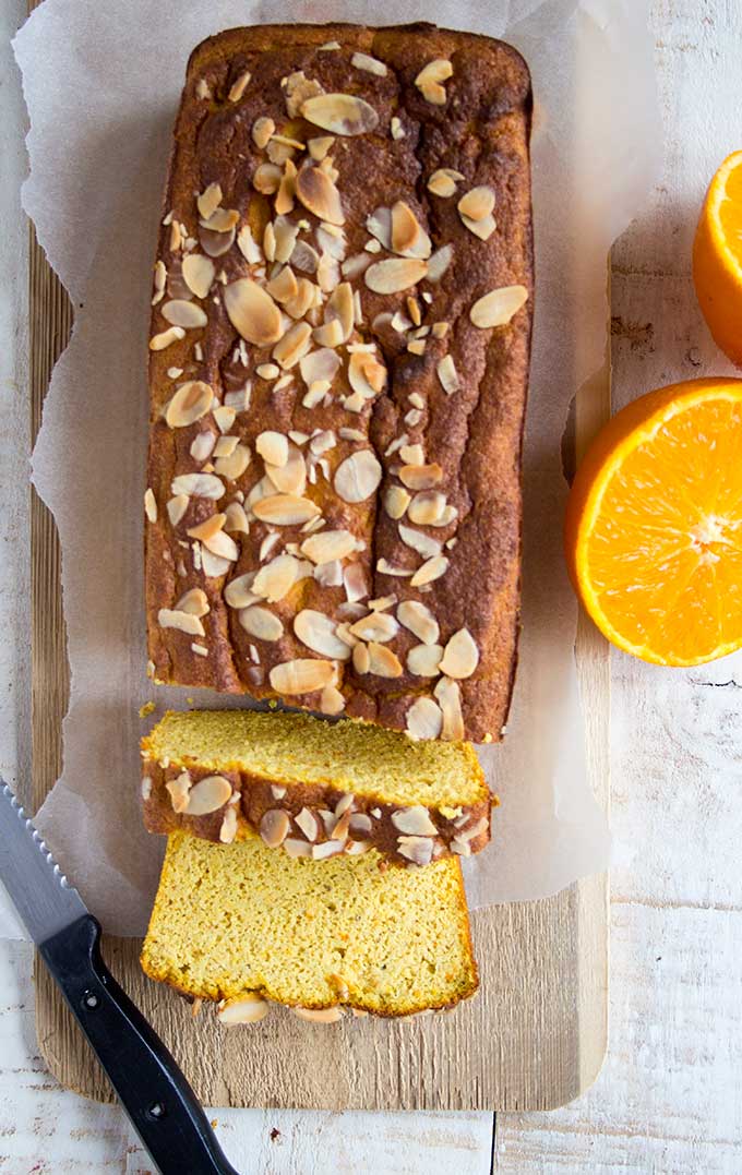 orange almond loaf cake with a knife