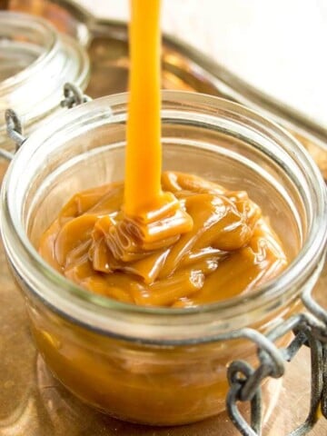 sugar free caramel sauce being poured into a glass jar