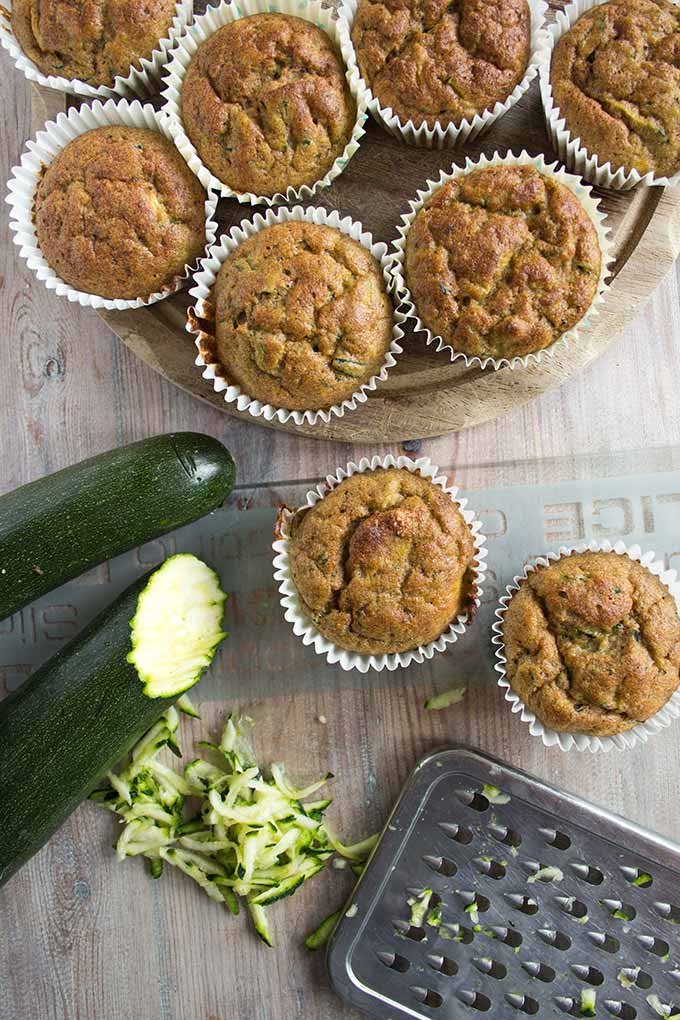 Low carb zucchini muffins with grated zucchini on a table