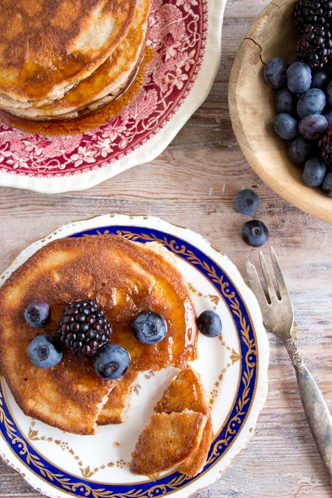 Paleo coconut flour pancakes on a plate with berries 