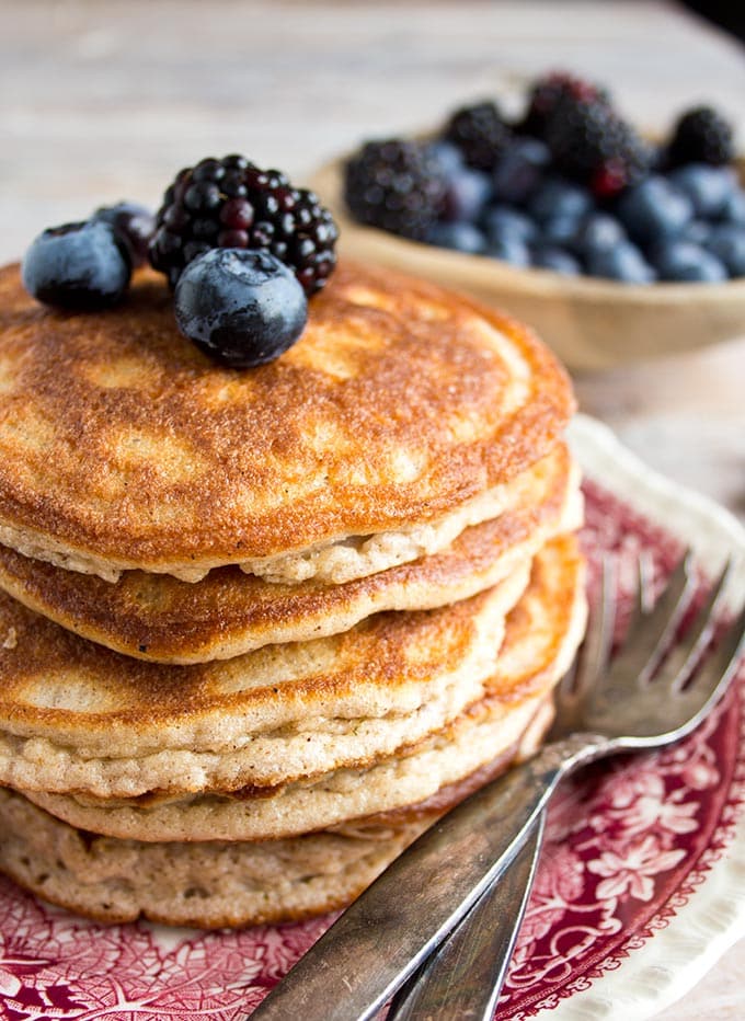 A stack of coconut flour pancakes with berries