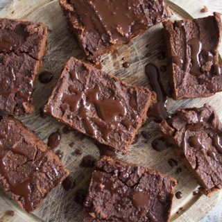 Fudgy Pumpkin Brownies on a round wooden tray