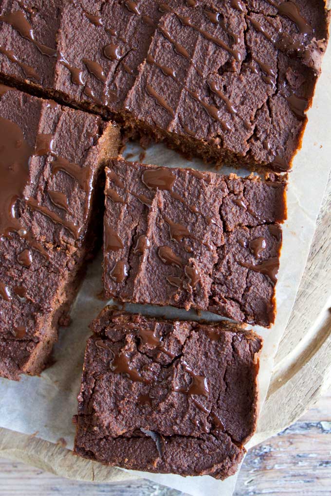 Fudgy Pumpkin Brownies cut into squares with chocolate drizzle