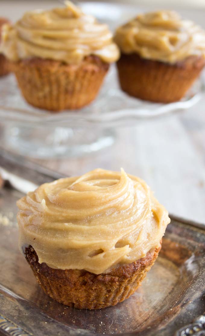 Gingerbread cupcake with salted caramel frosting on a tray.
