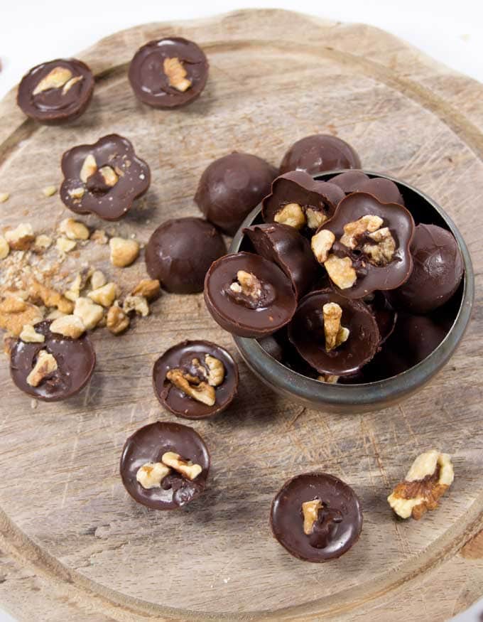 fat bombs in a silver bowl and scattered around a wooden board