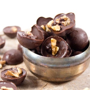 a silver bowl with chocolate walnut fat bombs