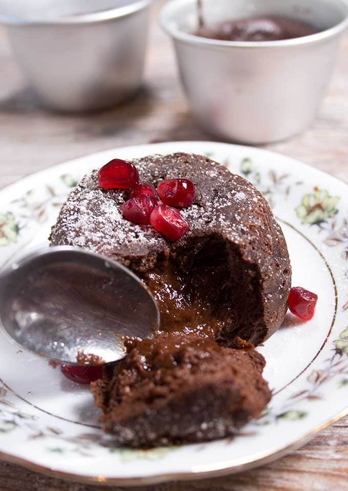 taking a spoonful from a lava cake showing the gooey inside