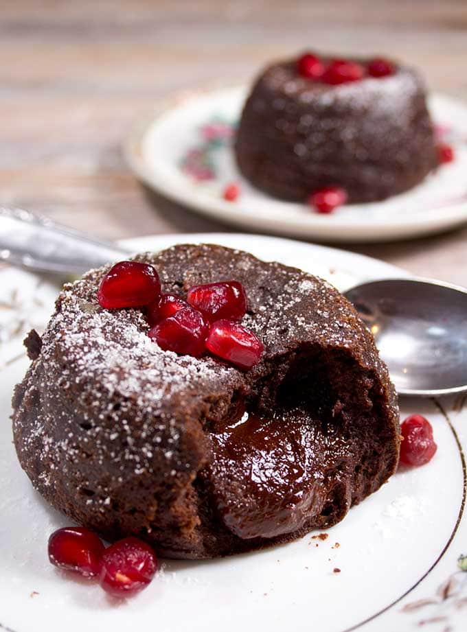 A chocolate lava cake with a gooey molten centre on a plate