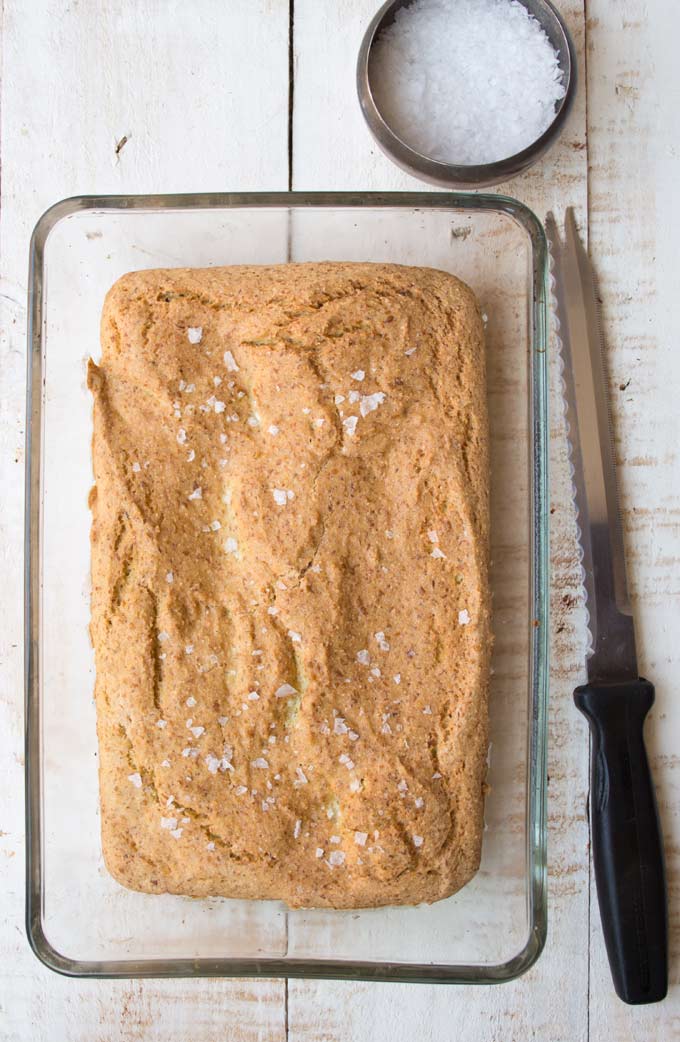 A keto flaxseed bread loaf with a knife