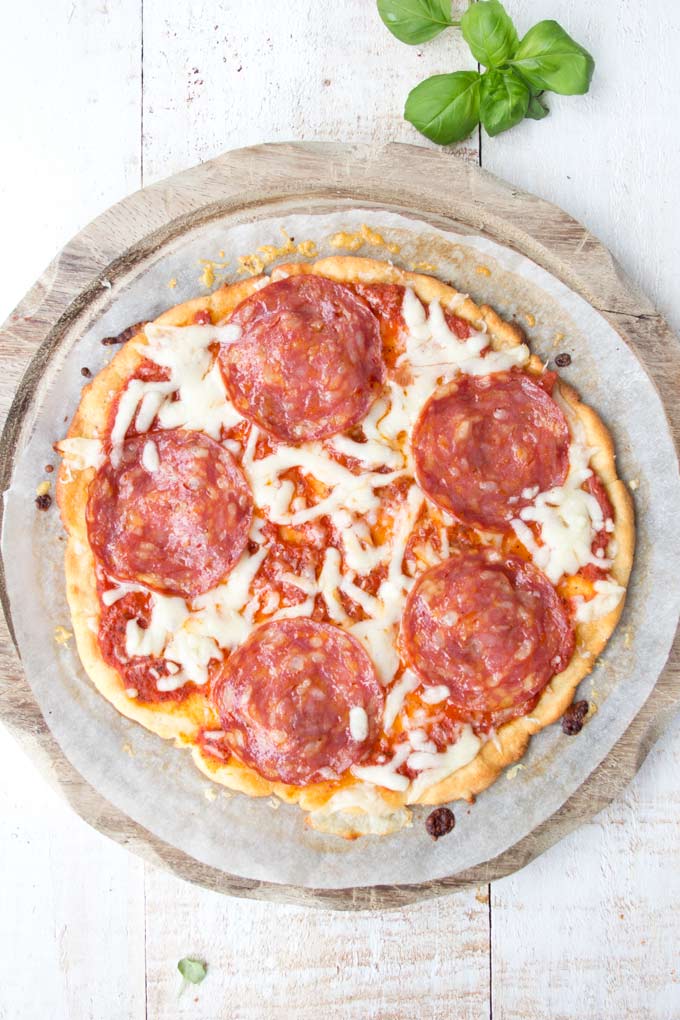 A low carb pizza on a wooden tray