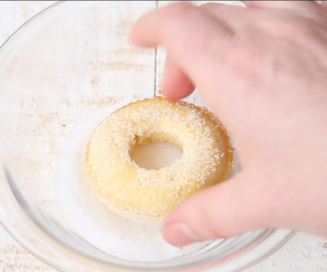rolling a donut in sugar free sweetener