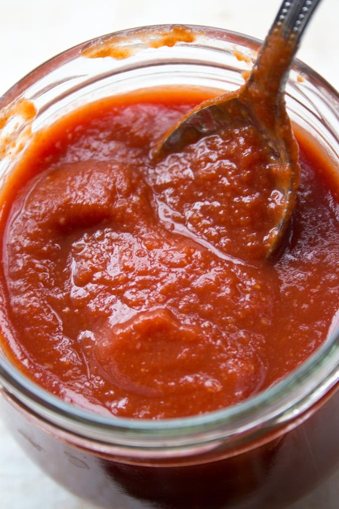 Low carb sugar free BBQ sauce in a glass jar with spoon