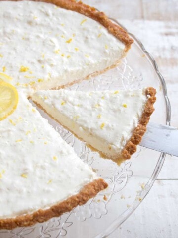 Cutting a slice of low carb lemon cheesecake tart