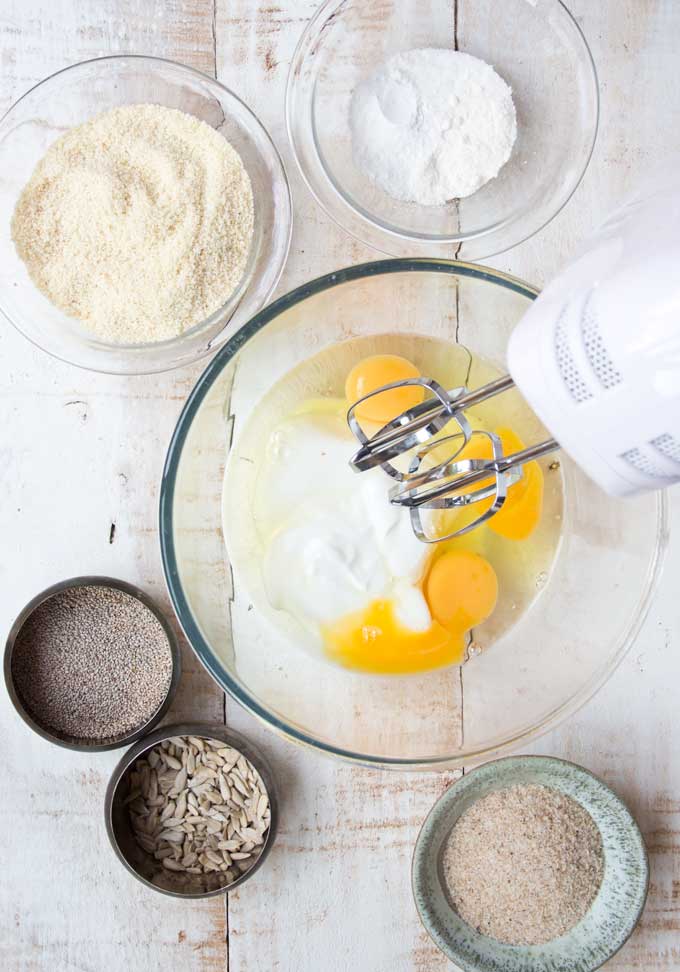 Several Bowls With Ingredients for Chia Almond low carb Bread About to be Mixed with an Electric Mixer 