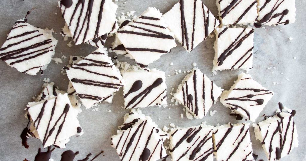 Sweet craving? These soft, chewy Keto coconut bars are healthy dessert heaven. NO-BAKE and made with only 5 ingredients, you'll never guess these decadent-tasting candy bars are low carb and sugar free!