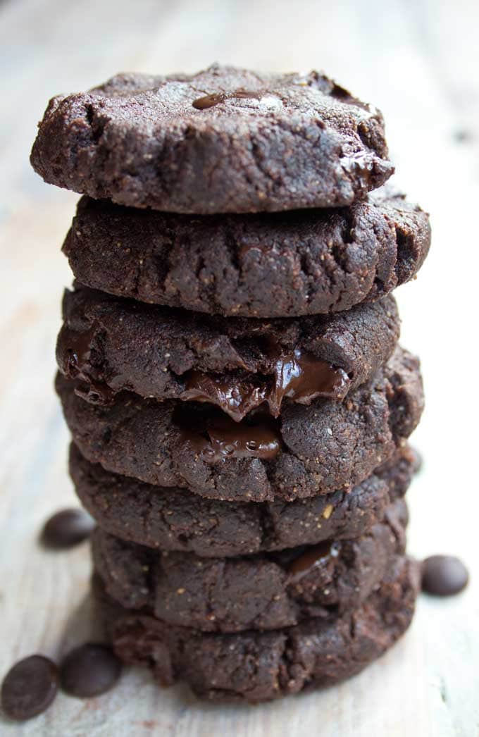 a stack of almond butter brownie cookies with chocolate chips 