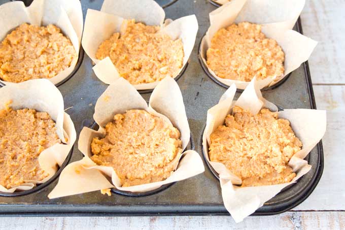 batter for healthy pumpkin muffins in paper cups before baking
