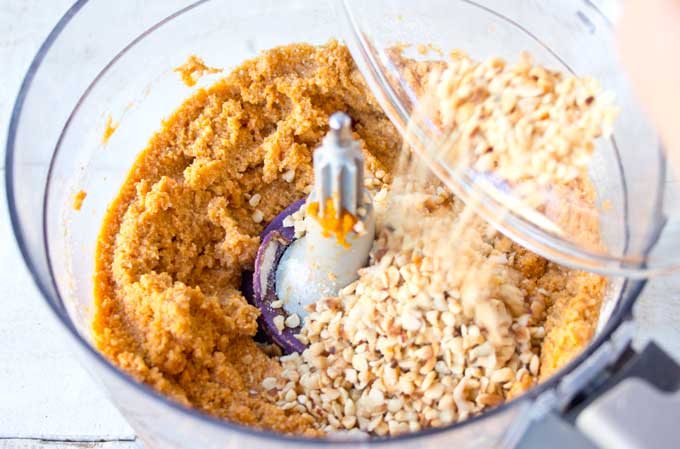 Pumpkin muffins batter and roasted hazelnuts in a food processor