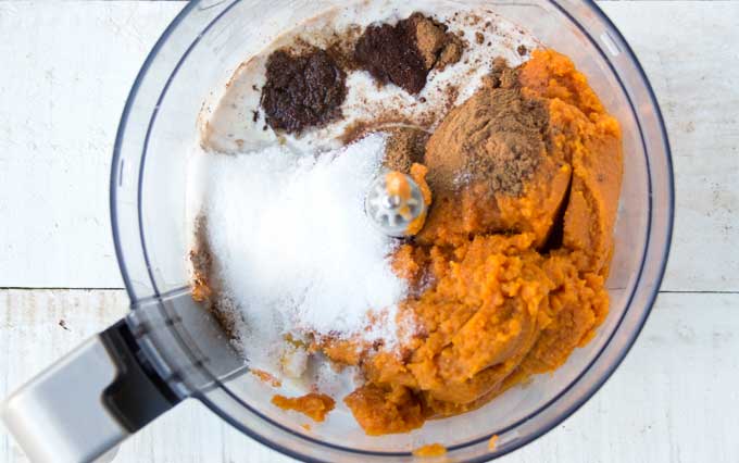 pumpkin puree and other ingredients in a food processor bowl