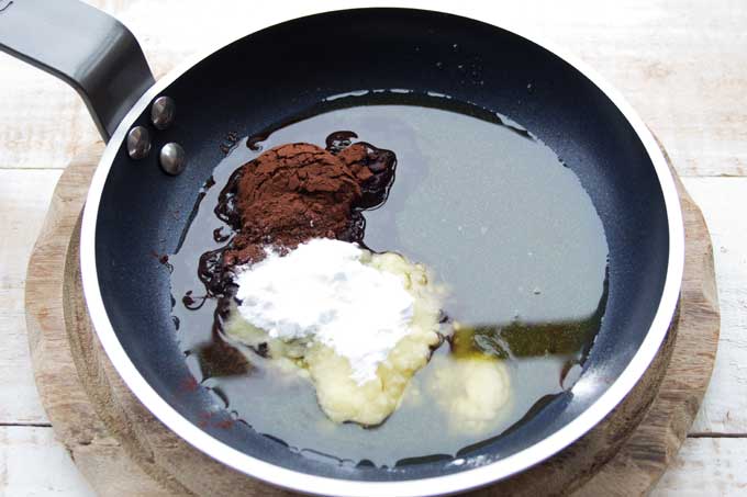 Melted cocoa butter with cocoa powder and powdered sweetener in a pan