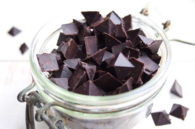 an open glass jar fille with sugar free chocolate chips