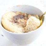 cinnamon swirl coconut flour mug cake with a spoon