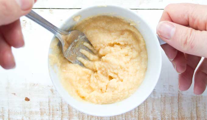 Stirring the batter for a coconut flour mug cake with a fork