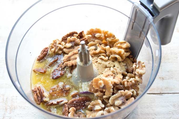 Ingredients for the crust in a food processor bowl .