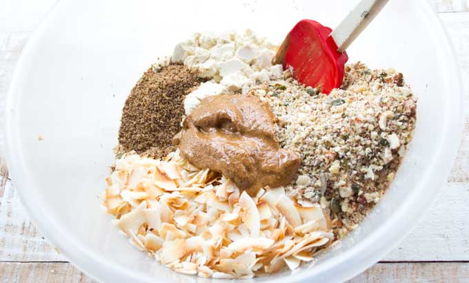 ingredients for sugar free low carb granola in a bowl with a spatula