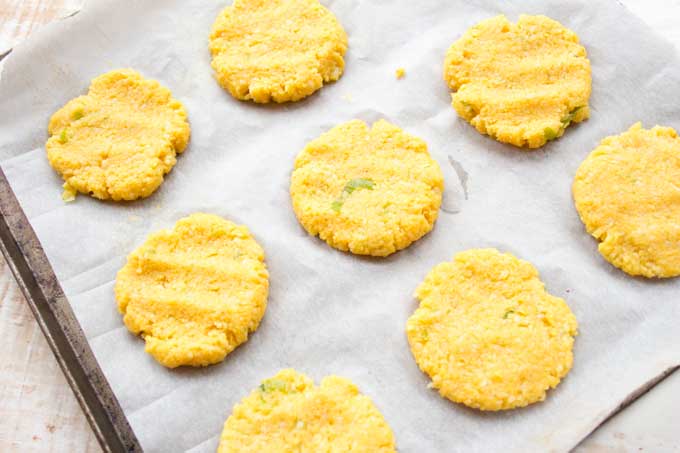 unbaked cauliflower fritters on a baking tray