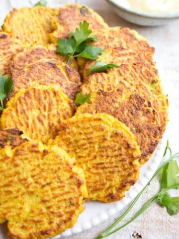 a plate with cauliflower hash browns and parsley decoration