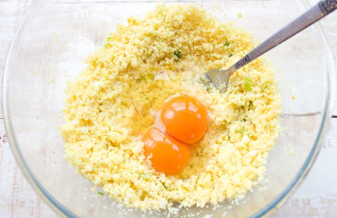 adding 2 eggs to the cauliflower hash brown dough