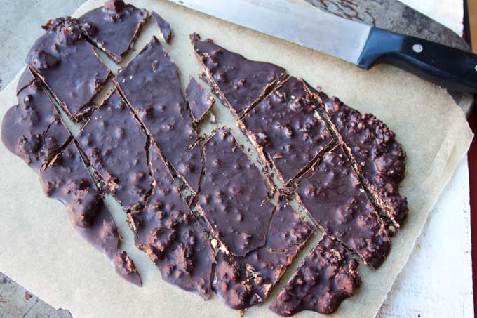 low carb chocolate bark broken into pieces and a knife