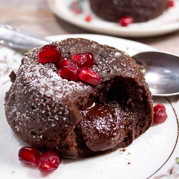 a low carb chocolate lava cake on a plate with the molten inside visible and a spoon