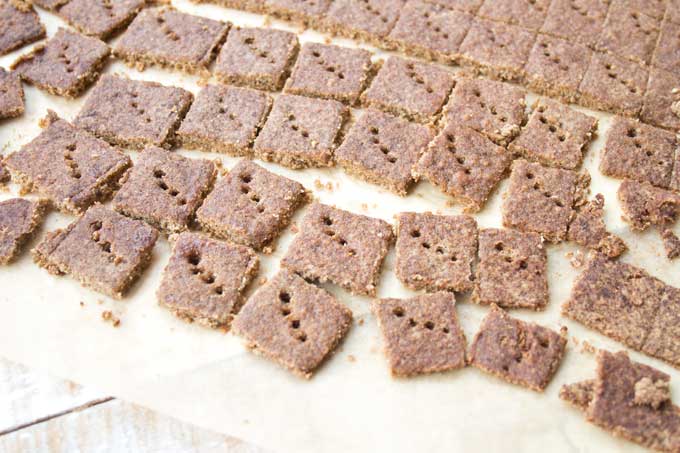 Keto cinnamon crunch cereal squares adter baking on parchment paper