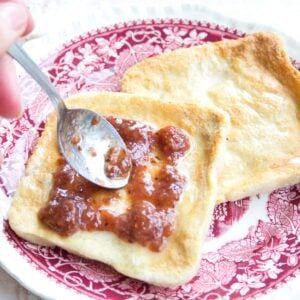 2 sliced of keto bread with butter and jam on a plate