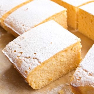 keto lemon bars sliced and topped with powdered sweetener